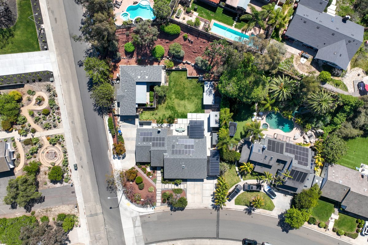 An aerial view of a San Diego neighborhood with landscaped yards and pools